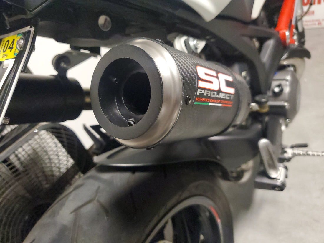 How does a DB killer reduce the noise level of an exhaust system?