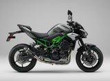 Kawasak motorcycle parked on a concrete surface with a textured wall background